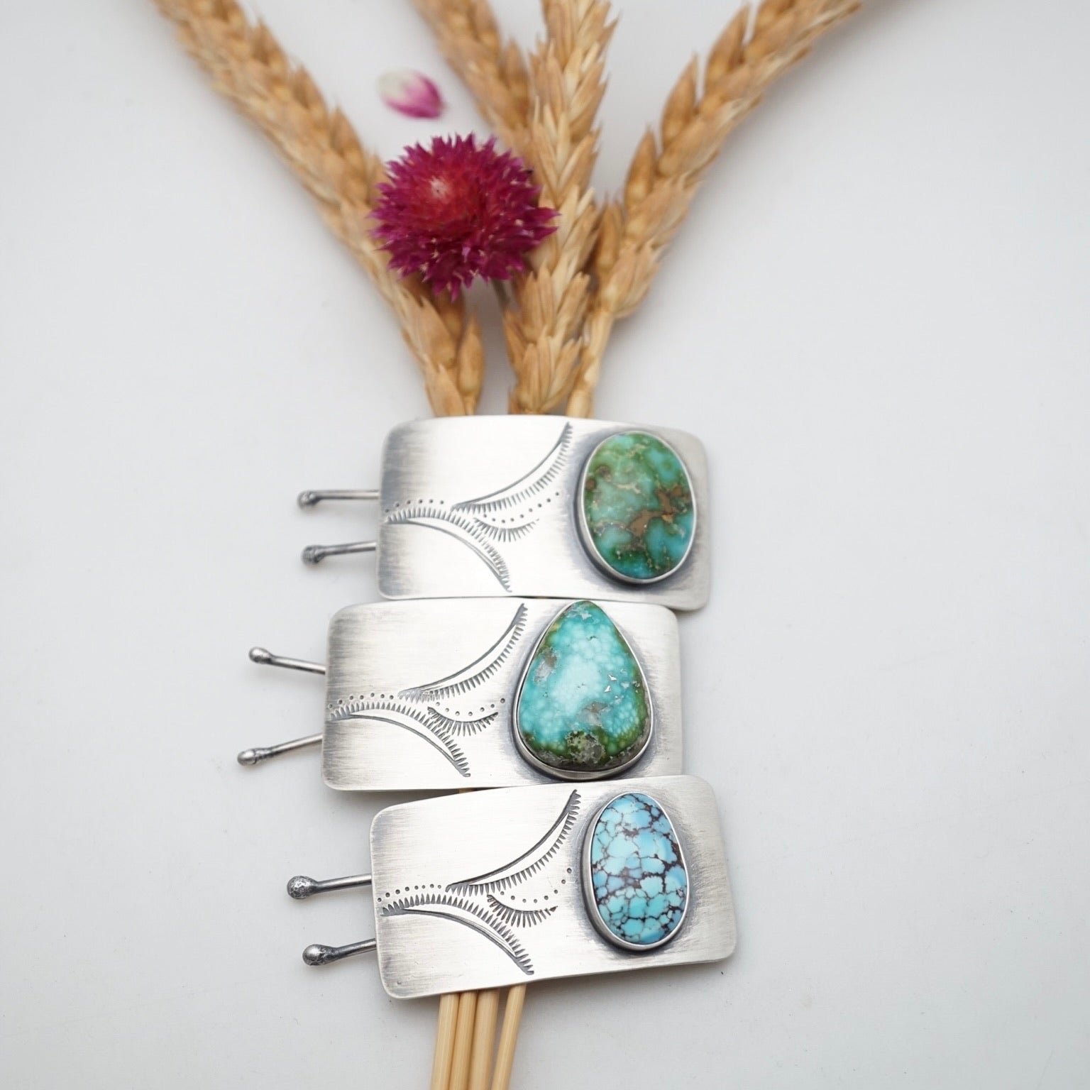 three silver and turquoise hair barrettes 