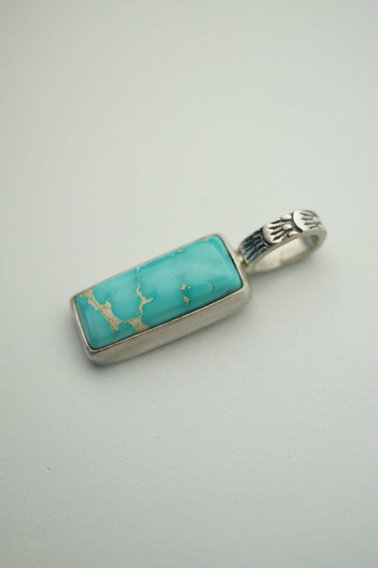 turquoise bar pendant in sterling silver on a white background