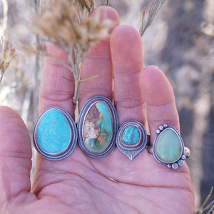 picture of four (4) turquoise rings 